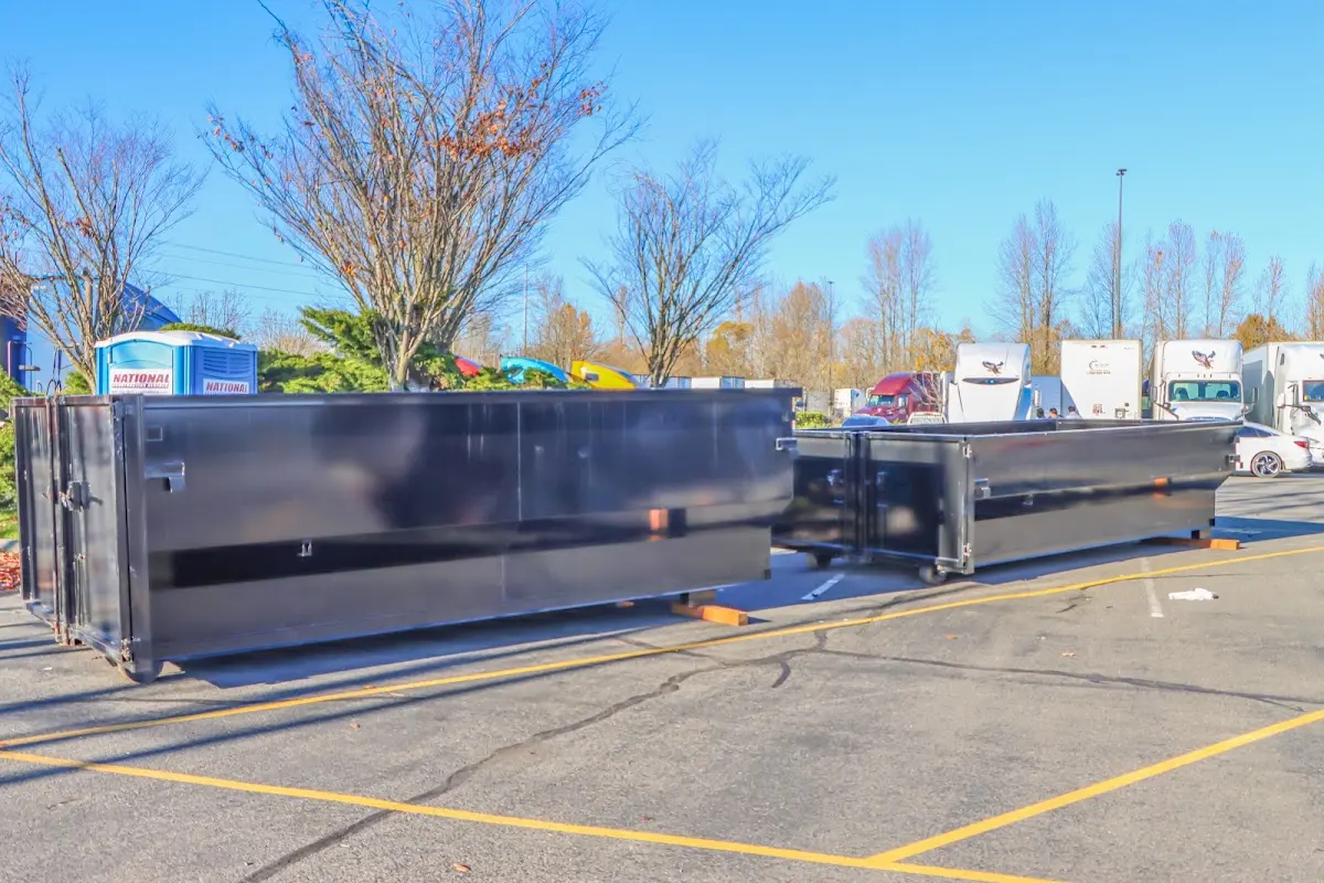 Professional dumpster rental service with roll-off container on residential driveway in Mount Prospect